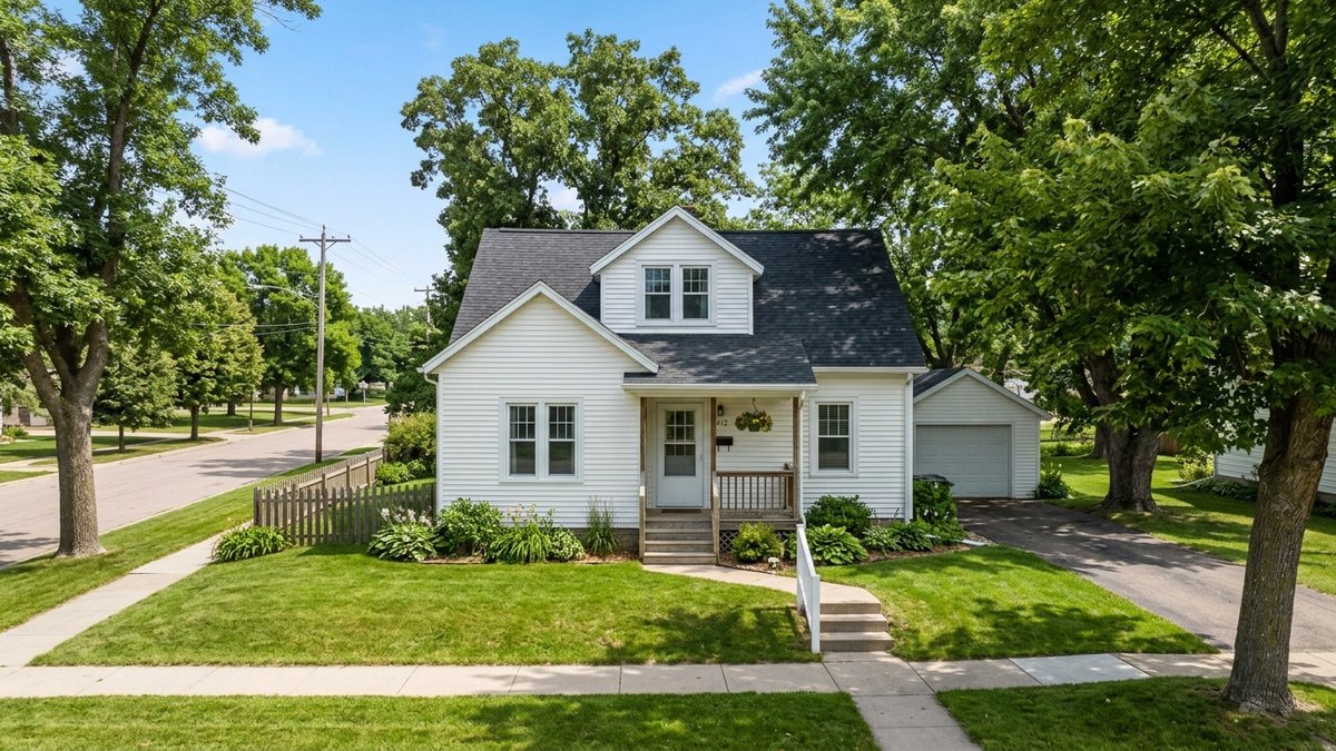 Older modest Yankton home exterior with mature trees and everyday curb appeal. Useful for starter-home and resale posts.